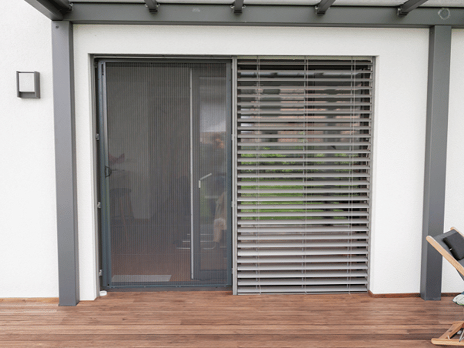 Pleated insect screen installed beside a terrace door