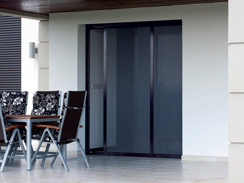 Sliding insect screen installed across a wide exterior opening